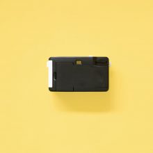 Kodak i60 35mm Film Camera Blue back on yellow background