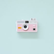 Kodak i60 Film Camera Pink Front Flash Kodak i60 35mm Film Camera Pink with flash up on teal background
