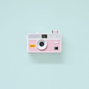 Kodak i60 35mm Film Camera Pink with flash up on teal background