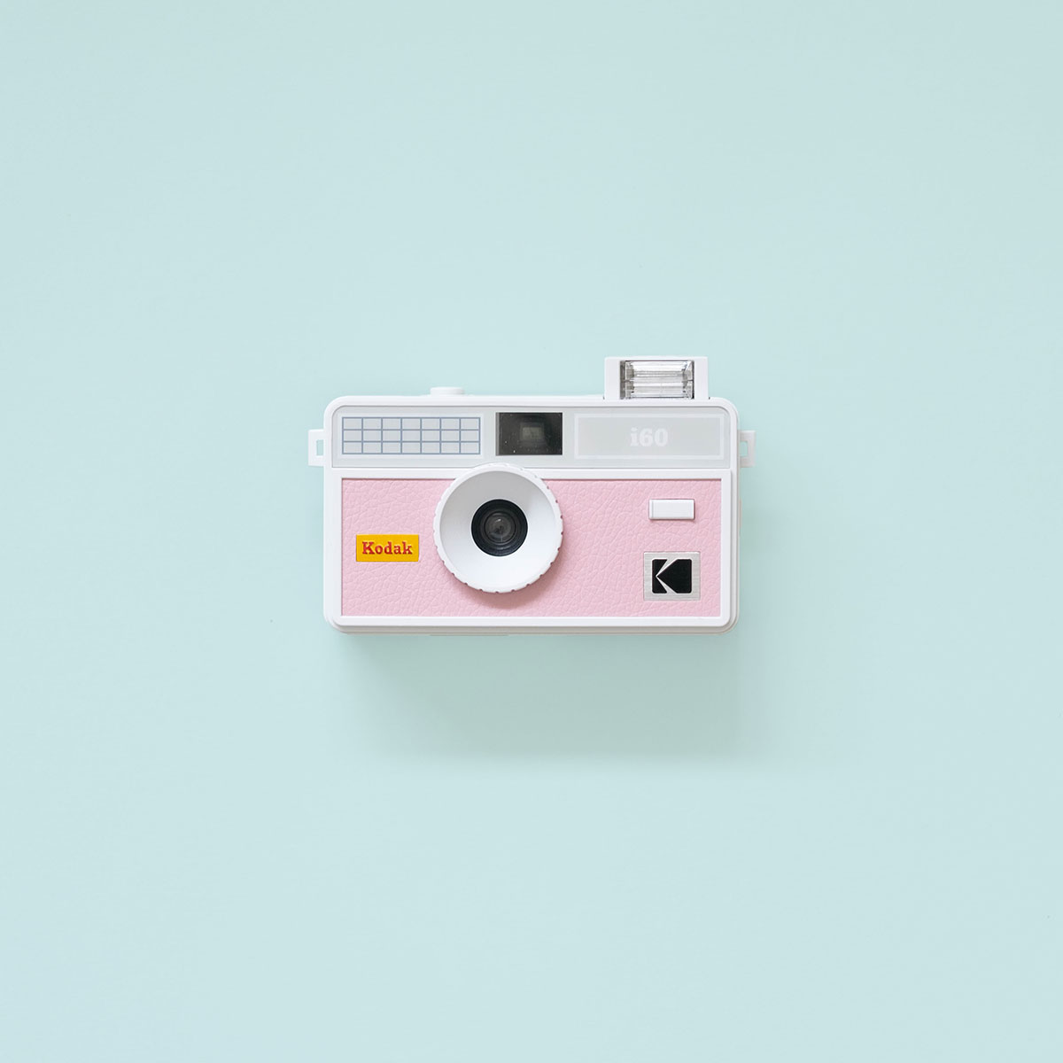 Kodak i60 Film Camera Pink Front Flash Kodak i60 35mm Film Camera Pink with flash up on teal background
