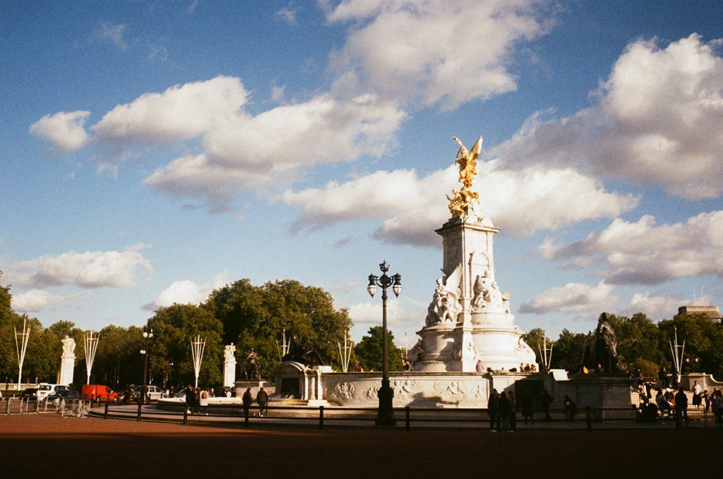 Outside Bucking Palace on a sunny day.