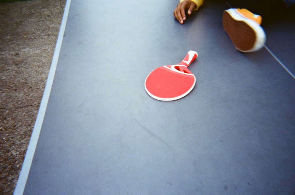 Red table tennis bat on table colour 35mm film