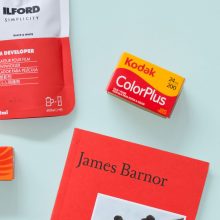 Analogue Photography Gift Guide 2024 - Film Developer Kodak 35mm Film and a James Barnor book on a light green background