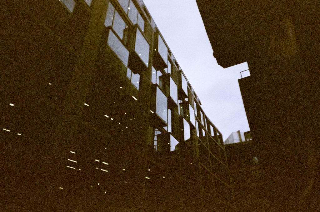 Windows on an office block, taken on 35mm film with retro look