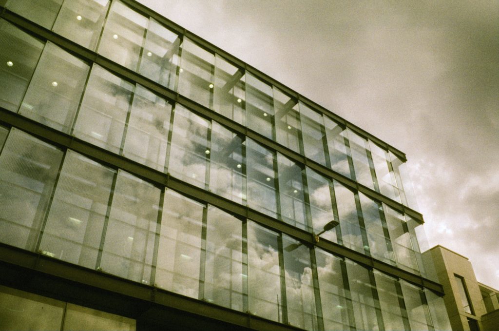 Clouds reflected in glass building. Taken on Phoenix II 35mm film
