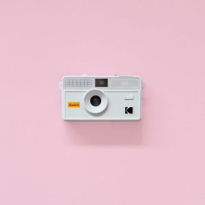 Kodak i60 35mm Film Camera Green flash down on pink background