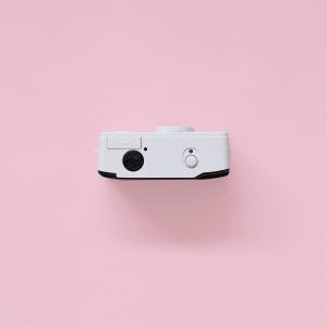 Kodak i60 35mm Film Camera Green top view on pink background