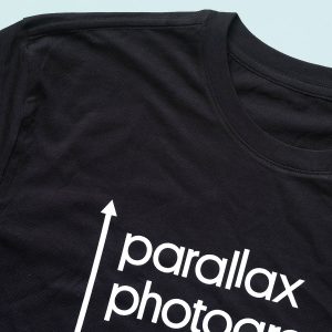 Parallax Photographic Coop T-shirt has our logo in white on a 100% organic black cotton shirt.